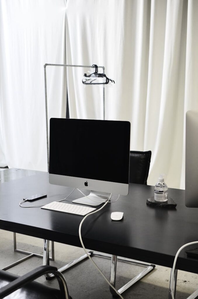 Modern workspace with computer and smartphone on table